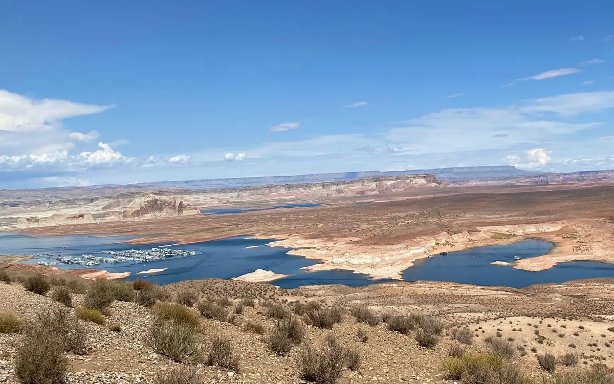 Blaues Wasser zwischen kahlen Wüstenfelsen unter weitem Himmel
